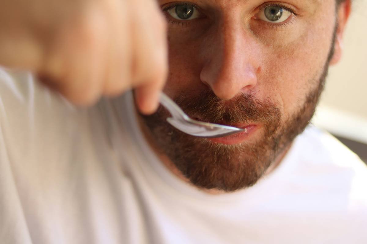 Side-by-side comparison of plastic vs. acetate beard combs under magnification showing tooth smoothness